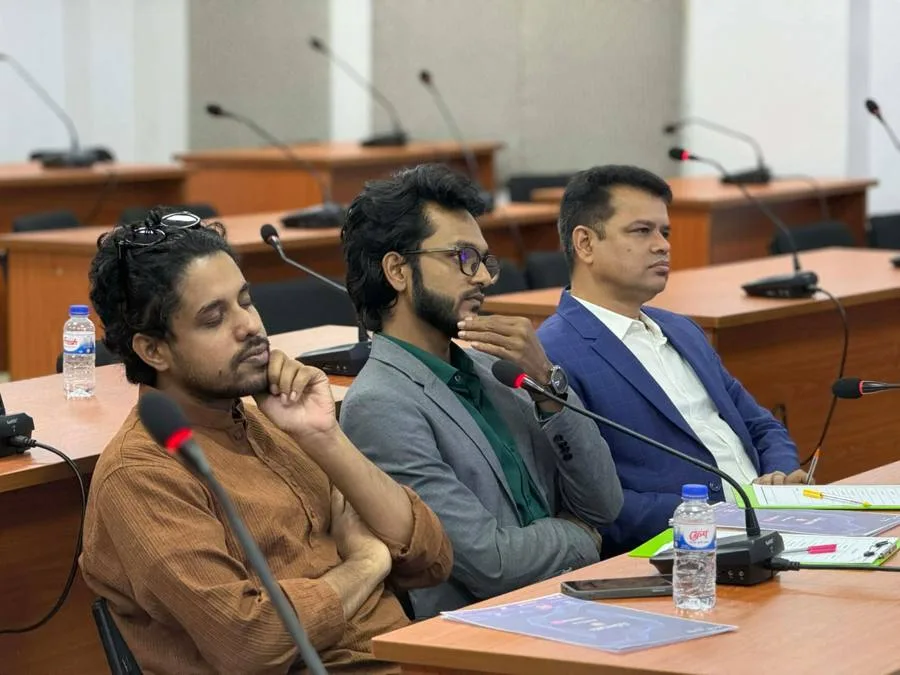 Giash Shaheen seated on a panel